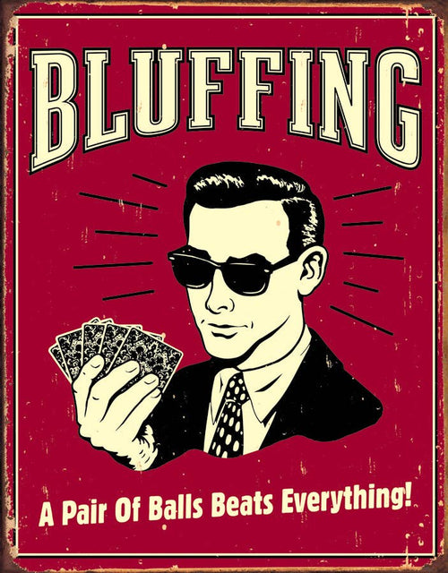Bluffing tin sign with playing-card artwork and A Pair of Balls Beats Everything slogan