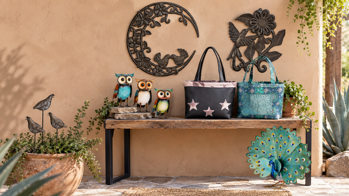 Southwest patio display with a wooden bench, metal wall art, owl figurines, handmade tote bags, potted plants, and peacock garden decor.